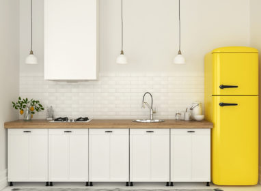 Bright kitchen with white furniture and a bright yellow fridge